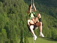 Mountainclimbing couple having sex hanging on a rope